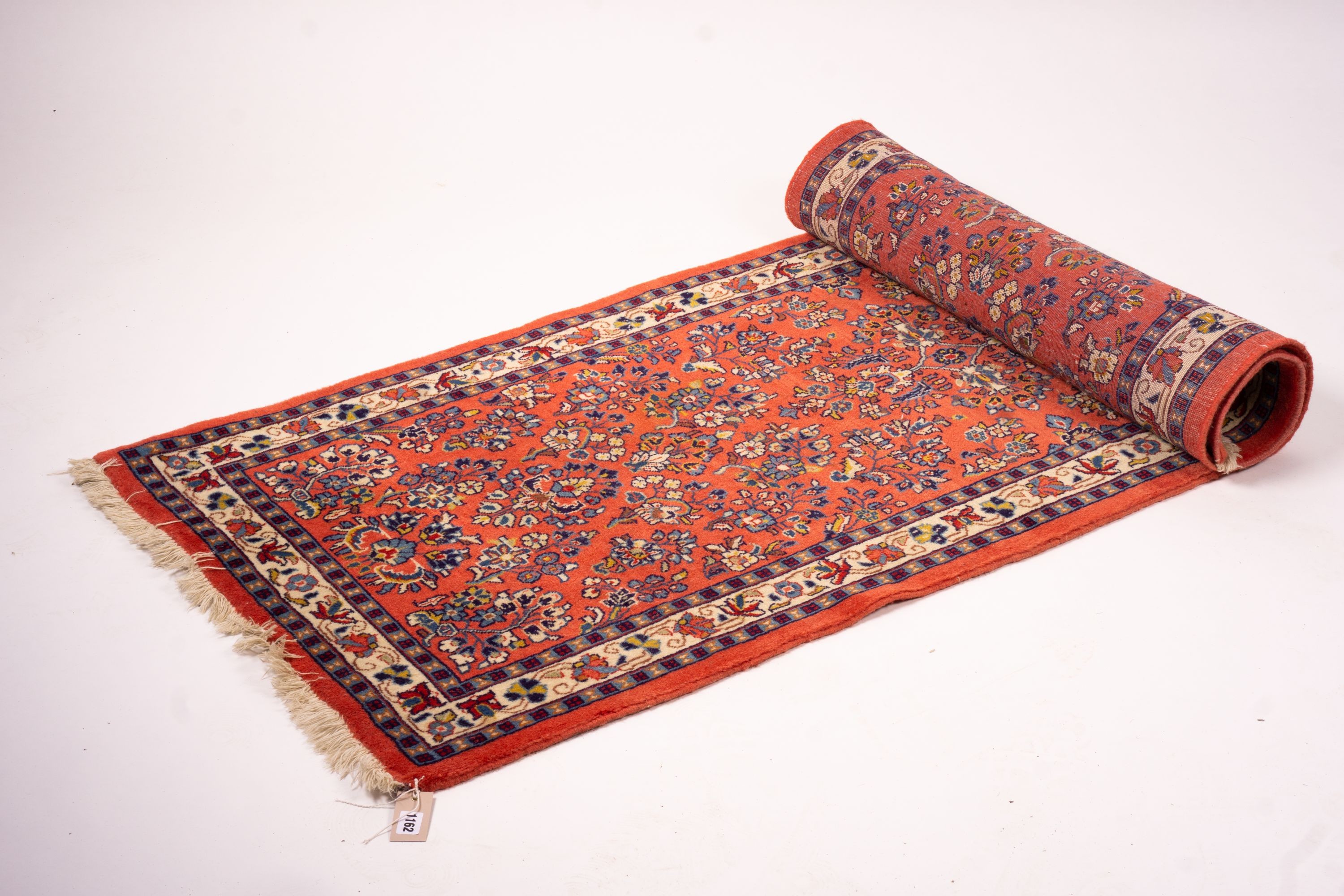 A Persian red ground runner, 202 x 83cm